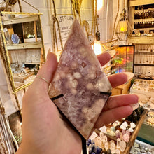 Load image into Gallery viewer, Side view of the pink amethyst standing on its metal stand - Let's Jam, Camden Town
