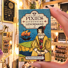 Load image into Gallery viewer, Pixie’s Astounding Lenormand box held in the hand in the shop - Let's Jam, Camden Market
