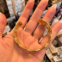 Load image into Gallery viewer, Plaited gold statement cuff seen from above in the hand - Let's Jam, Camden Market London
