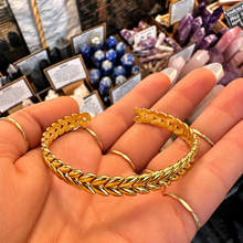 Load image into Gallery viewer, Plaited gold cuff seen from above in the hand - Let's Jam, Camden Town
