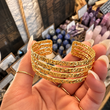 Load image into Gallery viewer, Front of the four band textured gold cuff held up - Let's Jam, Camden Market
