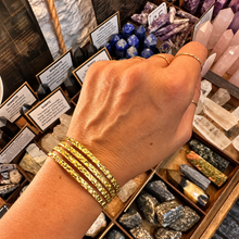 Load image into Gallery viewer, Four band textured gold cuff worn on the wrist - Let's Jam jewellery, Camden Town
