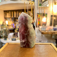 Load image into Gallery viewer, Rainbow fluorite tower in the shop with purple banding - Let's Jam, Camden Market, London
