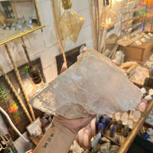 Load image into Gallery viewer, Raw calcite crystal chunk held in the hand to show its size - Let's Jam, Camden Town
