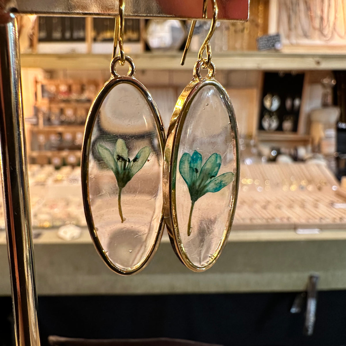 Oval resin earrings with a single real green flower - Let's Jam jewellery, Camden Town