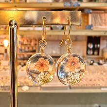 Load image into Gallery viewer, Round resin earrings with a real peach flower and tiny white blossoms on a gold stand - Let's Jam jewellery, Camden Town London
