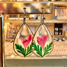 Load image into Gallery viewer, Teardrop resin earrings with a real pink-red flower and green leaves on a gold stand - Let's Jam, Camden Town
