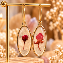 Load image into Gallery viewer, Oval resin earrings with a single real red flower hanging on a gold stand - Let's Jam, Camden Market
