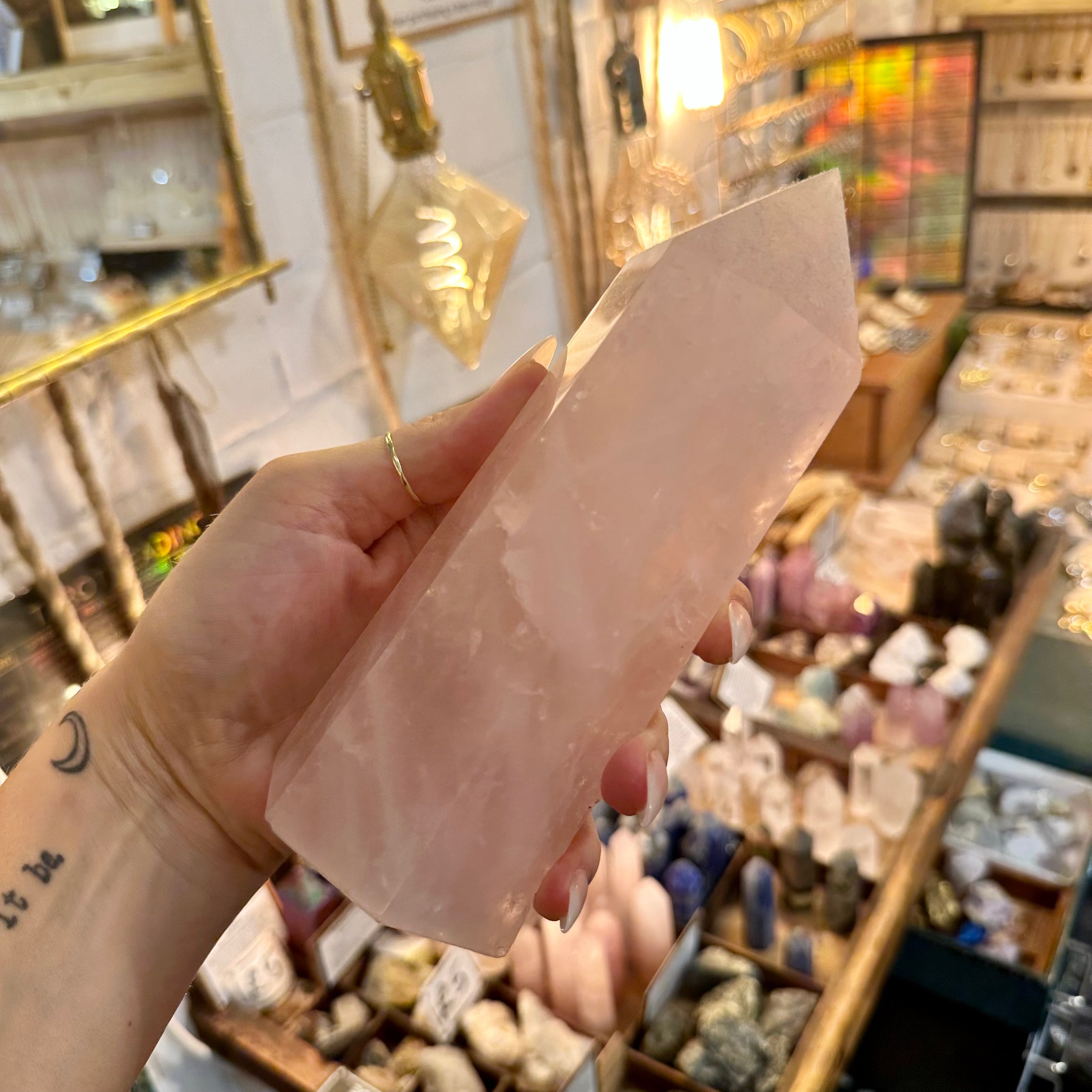 Rose quartz crystal tower held in the hand to show its size - Let's Jam, Camden Town London