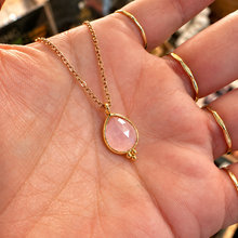 Load image into Gallery viewer, Faceted rose quartz tear drop pendant in a gold setting held in the hand - Let's Jam, Camden Market
