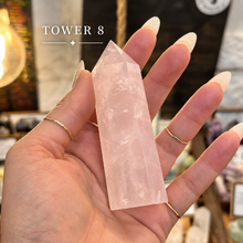 Load image into Gallery viewer, Rose quartz tower number eight held in the hand to show its size - Let's Jam, Camden Town London
