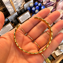 Load image into Gallery viewer, Open gold shell cuff laid in the palm - Let's Jam jewellery, Camden Town London
