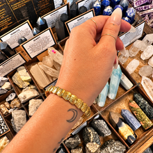 Load image into Gallery viewer, Gold shell cuff bangle worn on the wrist - Let's Jam, Camden Market London
