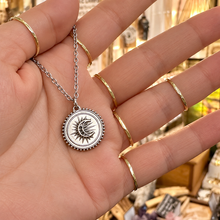 Load image into Gallery viewer, Silver sun and moon medal pendant held in the hand - Let's Jam, Camden Town
