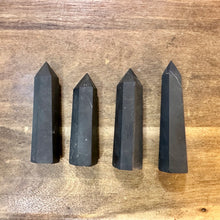 Load image into Gallery viewer, Four black shungite crystal towers lying on a wooden table - Let's Jam, Camden Market
