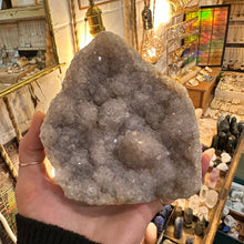 Load image into Gallery viewer, Super sparkly amethyst held in the hand to show its size - Let's Jam, Camden Town London
