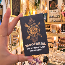 Load image into Gallery viewer, Tarotorial tarot training deck box held in the hand in the shop - Let's Jam, Camden Market
