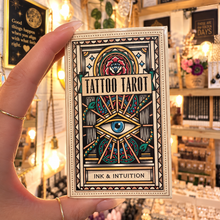 Load image into Gallery viewer, Tattoo Tarot Ink and Intuition box with its eye design, held in the hand - Let's Jam, Camden Market
