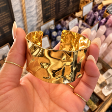 Load image into Gallery viewer, Front of the rippled gold statement cuff held up - Let's Jam, Camden Market, London
