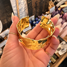 Load image into Gallery viewer, Wide textured gold cuff laid open in the palm - Let's Jam jewellery, Camden Market
