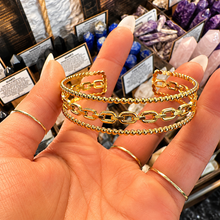Load image into Gallery viewer, Gold chain link cuff bangle held in the hand - Let's Jam, Camden Market
