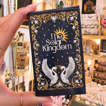 Load image into Gallery viewer, The Solar Kingdom Tarot box in midnight blue and gold, held in the hand - Let's Jam, Camden Market
