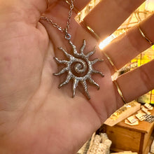 Load image into Gallery viewer, Silver spiral sun pendant held in the hand - Let's Jam, Camden Town
