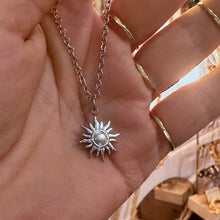 Load image into Gallery viewer, Silver sun pendant held in the hand - Let's Jam, Camden Town London
