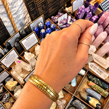 Load image into Gallery viewer, Gold braided cuff bangle worn on the wrist - Let's Jam, Camden Town London
