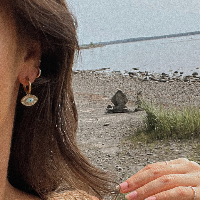 Gold third eye hoop earring worn on the ear by the sea - Let's Jam, Camden Market London