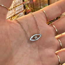 Load image into Gallery viewer, Silver third eye pendant with a sparkling stone held in the hand - Let's Jam, Camden Market London
