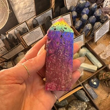 Load image into Gallery viewer, Titanium quartz obelisk held up to show its size and sparkle - Let's Jam, Camden Market London
