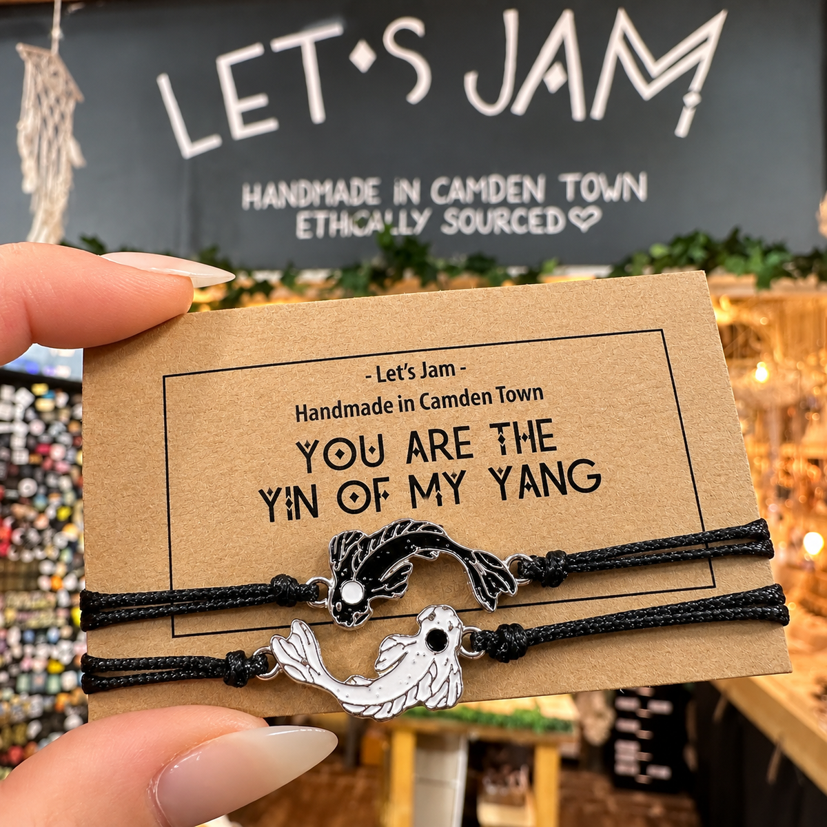 Two black cord bracelets with yin and yang fish charms on a Let's Jam "You Are The Yin Of My Yang" card - Let's Jam, Camden Market, London