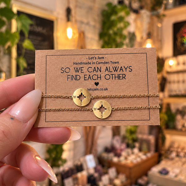 Two gold chain bracelets with compass charms on a So We Can Always Find Each Other gift card - Let's Jam, Camden Market London