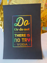 Load image into Gallery viewer, A black print with the Yoda quote "Do or do not, there is no try" in rainbow holographic lettering, displayed beside iridescent gift wrap - Let's Jam print collection

