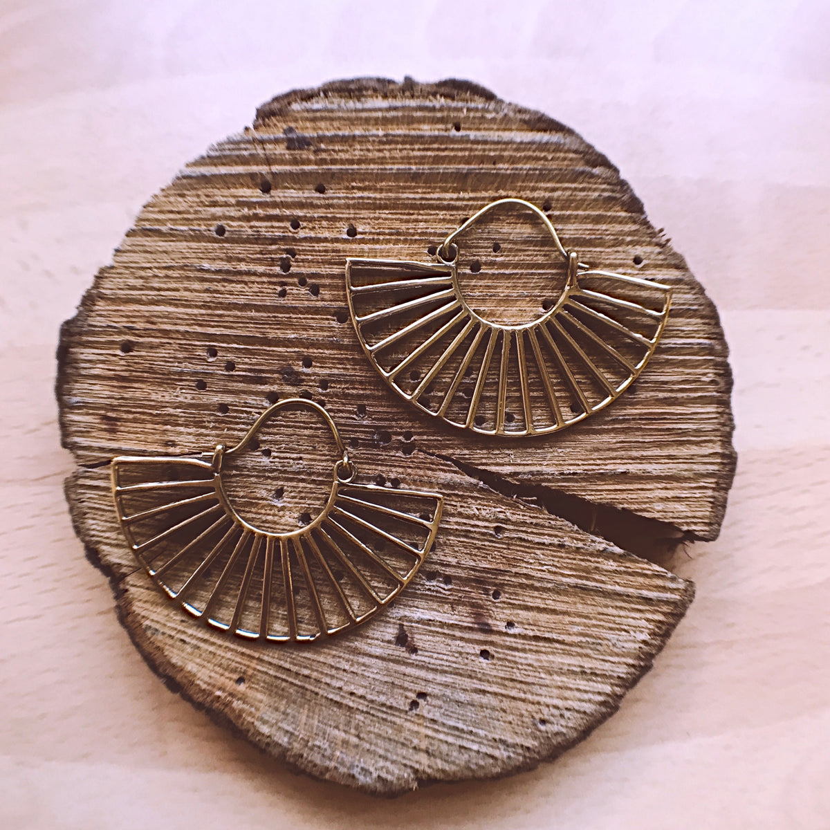 Pair of gold fan hoop earrings laid side by side - Let's Jam jewellery, Camden Town