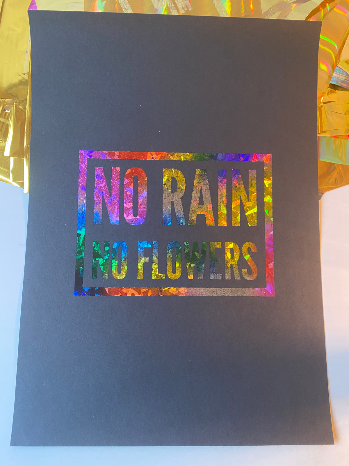 No Rain No Flowers mantra print in rainbow holographic lettering on black A4 - Let's Jam art prints, Camden Market