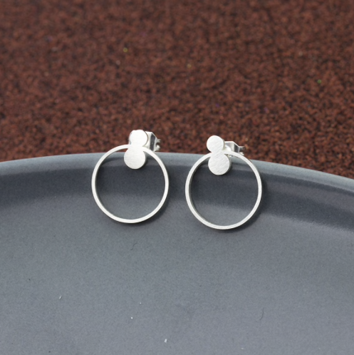 Pair of tiny circle studs on a plain background - Let's Jam, Camden Market