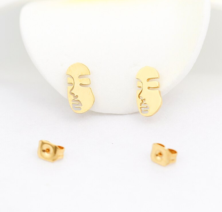 Gold abstract face silhouette stud earrings on a white ceramic dish - Let's Jam jewellery collection