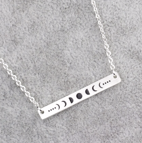 Silver moon phases bar bracelet laid flat on a fine chain - Let's Jam jewellery, Camden Town