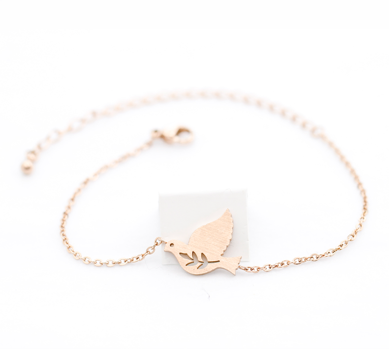 Dove bracelet worn on the wrist, charm resting on skin - Let's Jam, Camden Market, London