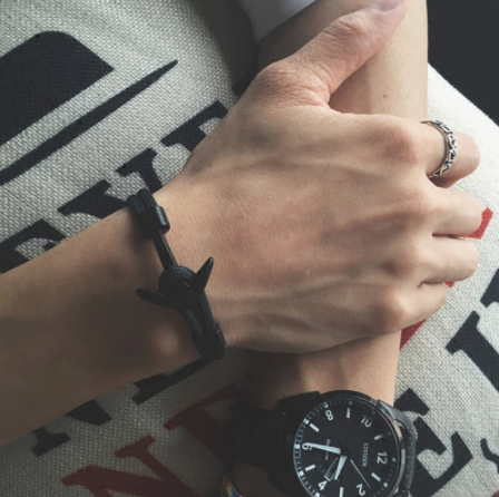 Black woven nylon men's bracelet with stainless steel anchor clasp detail, worn on wrist - Let's Jam jewellery collection
