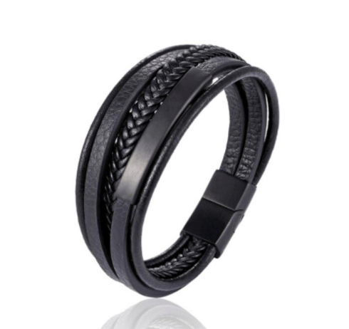 Black braided leather bracelet worn on the wrist, gold clasp on top - Let's Jam, Camden Market