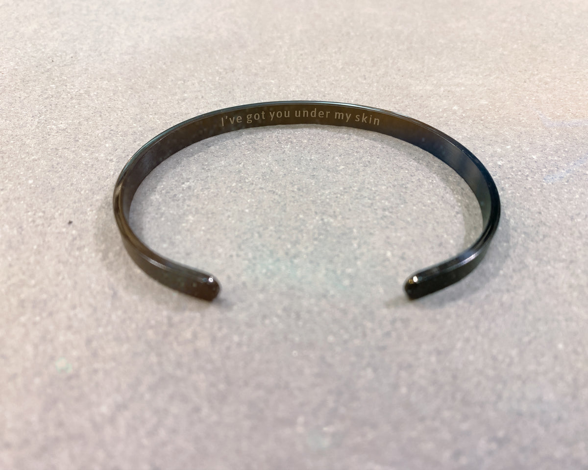 Black and silver hidden engraving cuffs shown together - Let's Jam, Camden Town London
