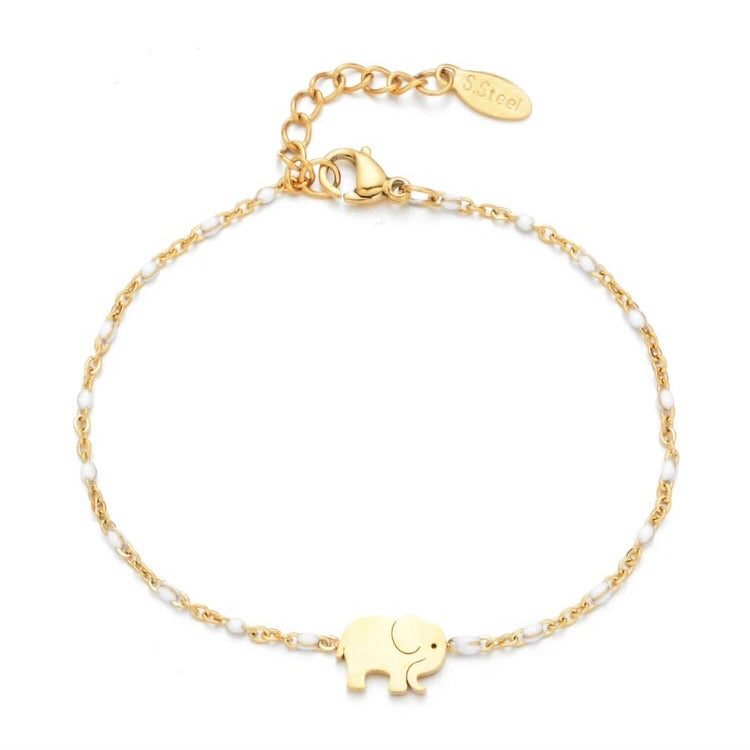 Enamel elephant bracelet held up against a white cushion - Let's Jam jewellery, Camden Market London