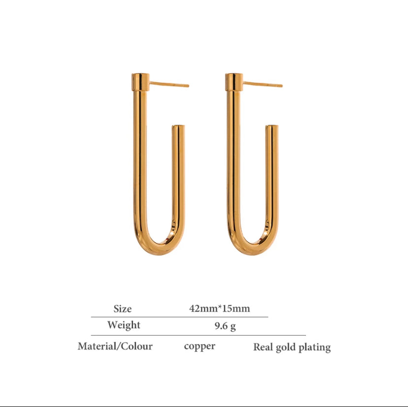 Statement U drop earrings in warm gold, laid flat on a plain surface - Let's Jam, Camden Market