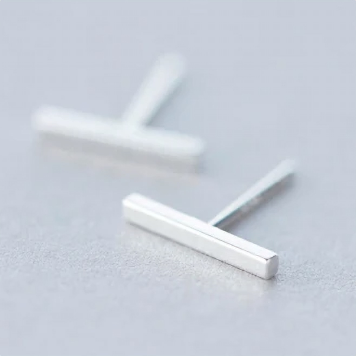 925 sterling silver minimalist bar stud earrings on a light grey surface - Let's Jam jewellery collection