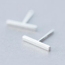 Load image into Gallery viewer, 925 sterling silver minimalist bar stud earrings on a light grey surface - Let's Jam jewellery collection
