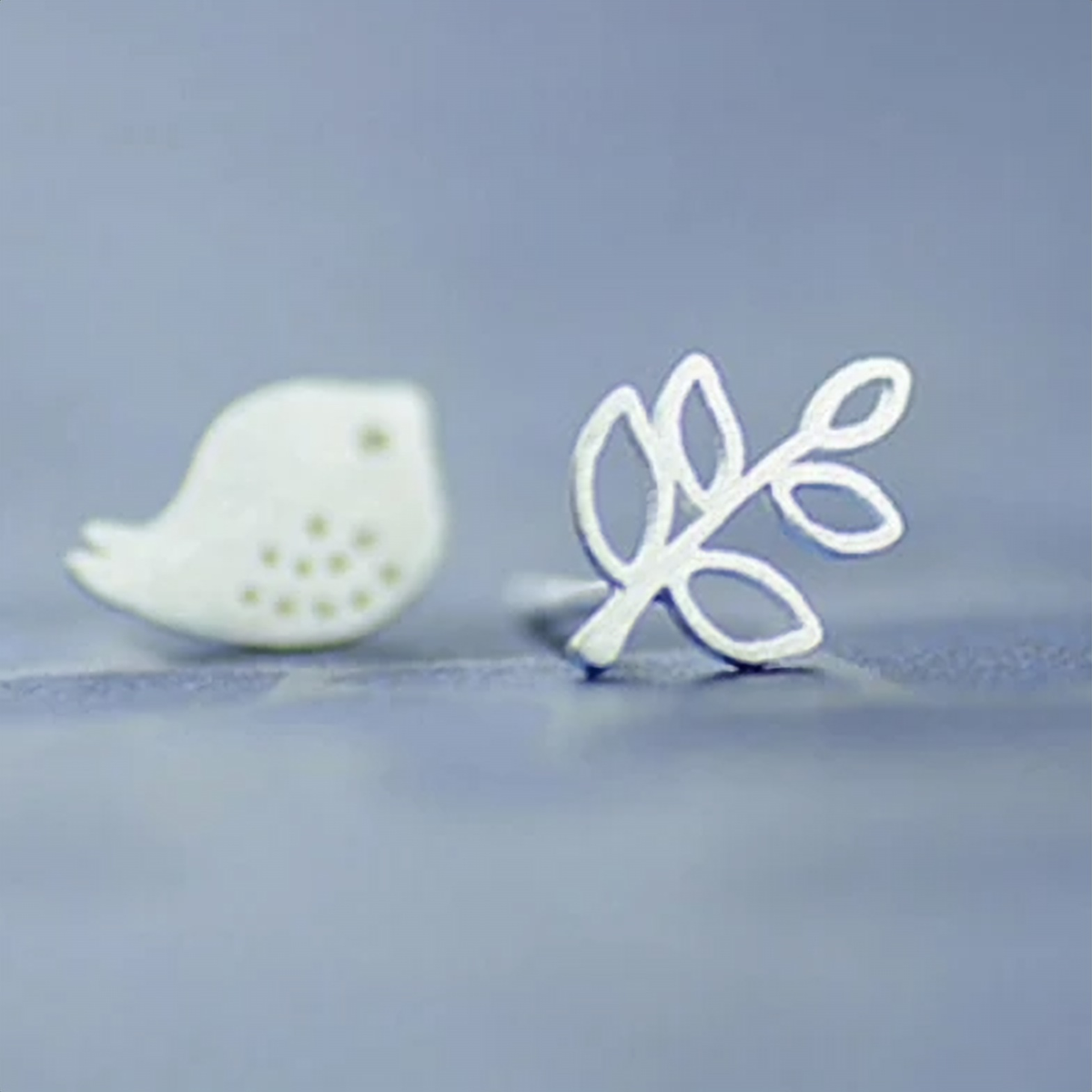 925 sterling silver mismatched bird and twig stud earrings on a lilac background - Let's Jam jewellery collection