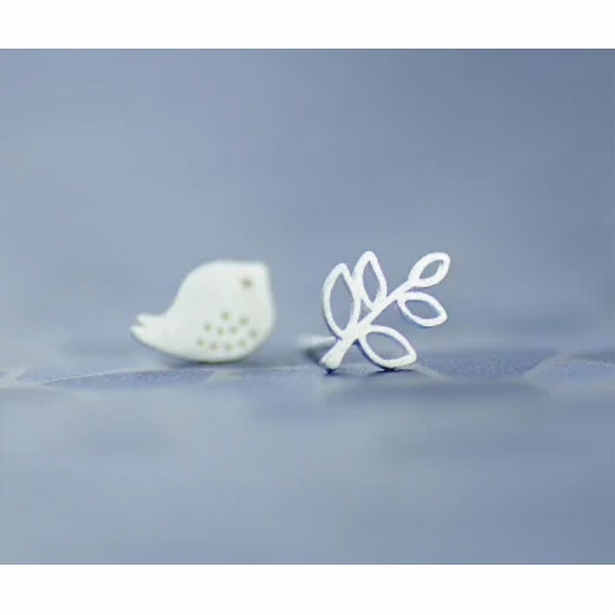 Mismatched bird and branch studs worn on the ear - Let's Jam jewellery, Camden Town